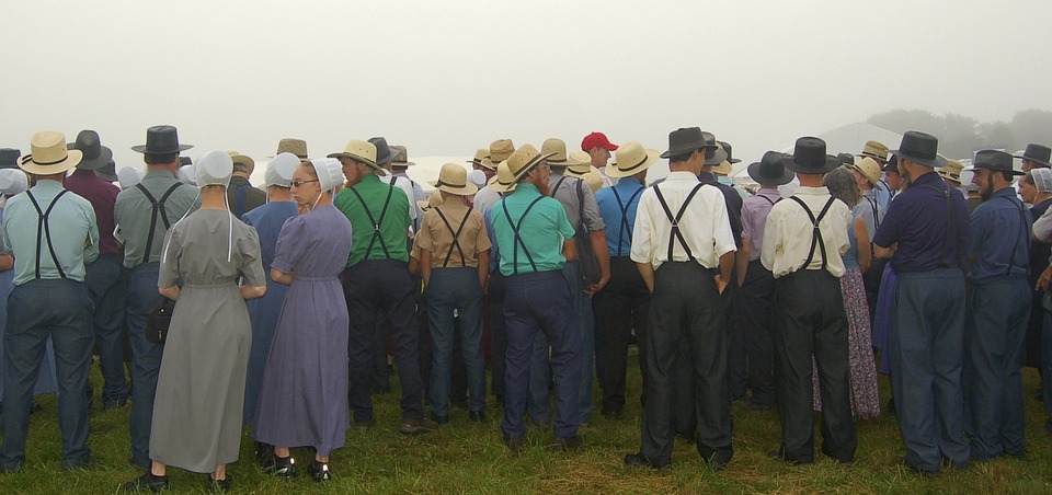 amish men and women standing with their backs turned
